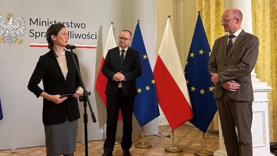 Picture of State Secretary Maria Varteressian, Minister of Justice  Bodnar and Rafto Prize Laureate  Ørstavik standing with flags in the background.