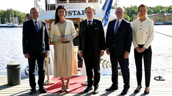 Bilde av nordiske utenriksministre stående foran en båt