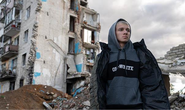 17-year-old Habriel stands at a bus stop riddled with shrapnel in the Ukrainian city of Izium. Here, 80 per cent of the landscape lies in ruins.