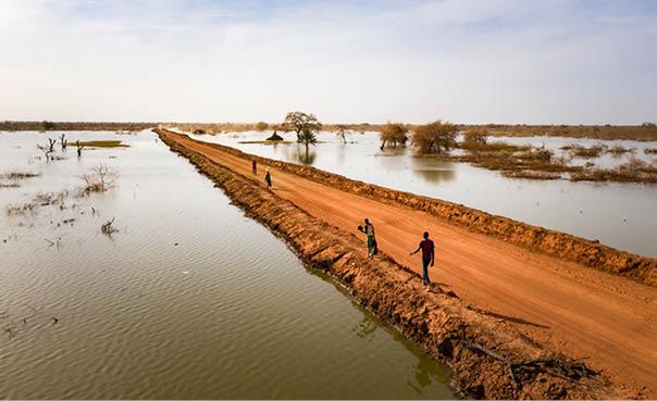 Thousands of people are permanently displaced after years of flooding in Bentiu, South Sudan. This road is protected by dykes and cuts through the floodwater. The road stretches all the way to the horizon, near Bentiu.