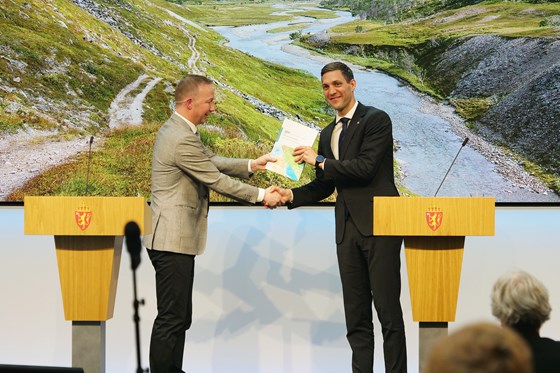 Utvalgsleder Jon Christian Fløysvik Nordrum overrekker utredningen til klima- og miljøminister Andreas Bjelland Eriksen