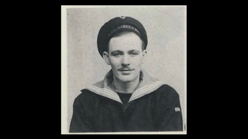 A black and white photo of the soldier, dressed in his uniform.