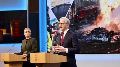 Justis- og beredskapsminister Emilie Enger Mehl og statsminister Jonas Gahr Støre står på scenen bak hver sin talerstol.